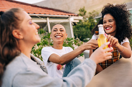Girlfriends making a toast with beers