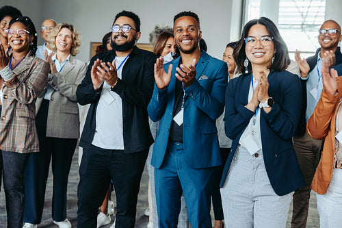 Diverse colleagues clapping at conference, happy employees celebrating success, unity in business