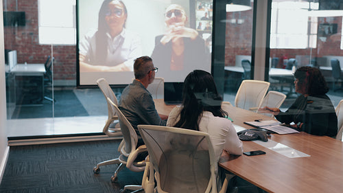 Conference meeting in an office, business people connecting with remote colleagues