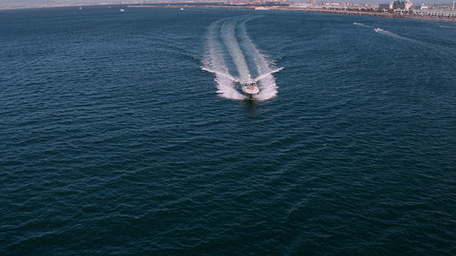 Yacht sailing in sea with young people on deck