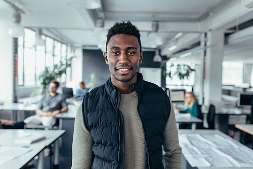 African male designer standing in modern office