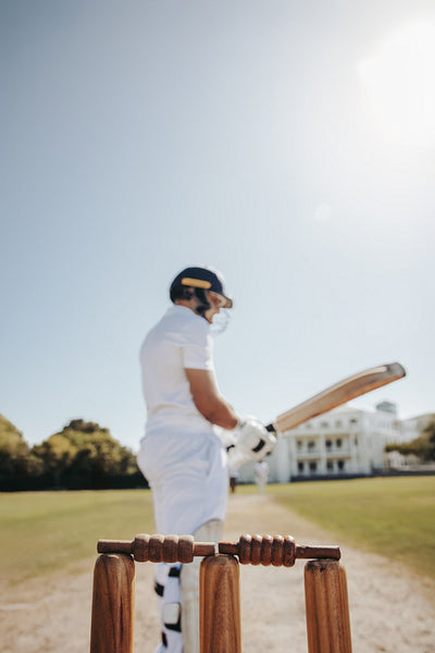 Close up of wickets with a batsman in the background