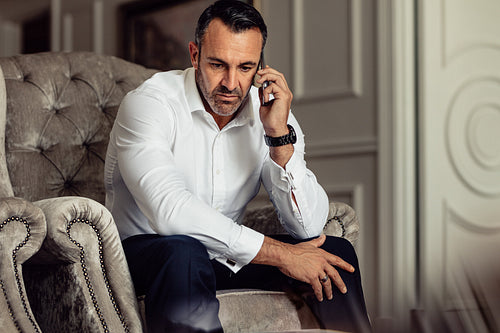 Businessman making a phone call after arriving in the hotel