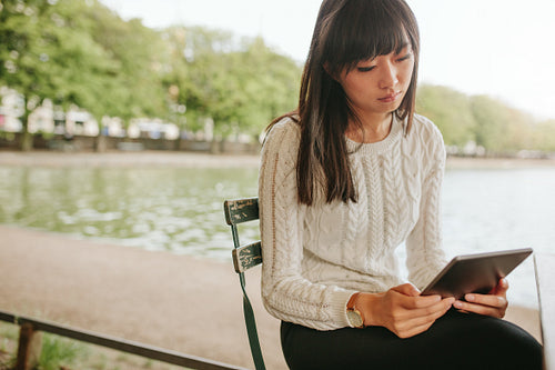 Young woman sitting at cafe with digital tablet