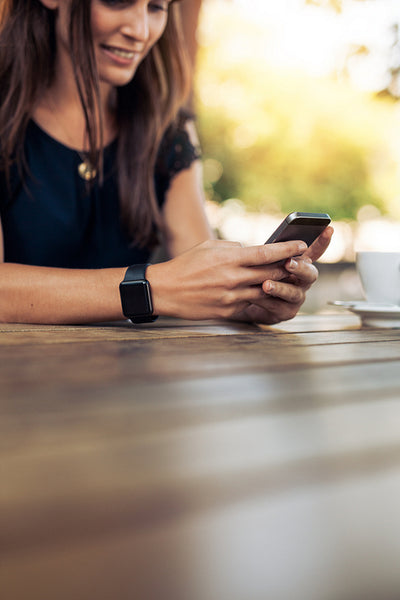 Woman using smart phone in a outdoor café