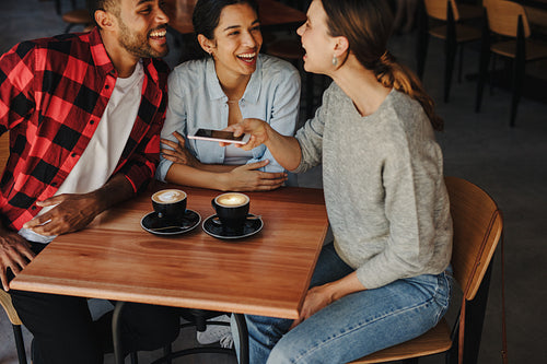 Group of friends meeting in a coffee shop