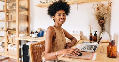 Female business owner working on laptop
