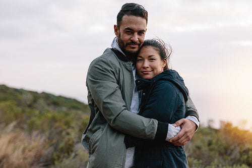 Beautiful young couple embracing in countryside