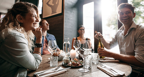Group of friends enjoying an evening meal at a restaurant