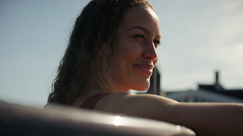 The woman settles into a luxury hot tub for a sunny outdoor wellness pause