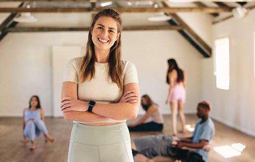 Female fitness instructor standing in a yoga class