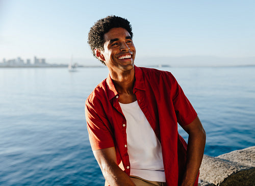 Joyful young man enjoying the day by Urca's wall