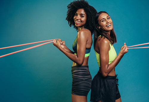 Females working out with resistance band