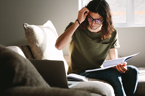 Student using laptop for reference while studying