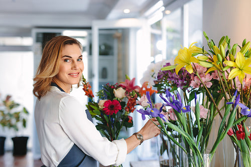 Female florist creating bouquet of flowers 
