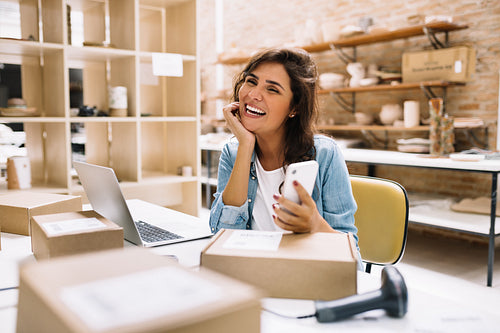 Successful online store owner smiling happily in a warehouse