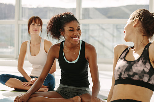 Woman relaxing and talking after yoga session