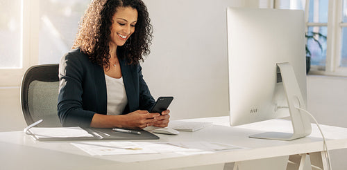 Businesswoman using mobile phone in office