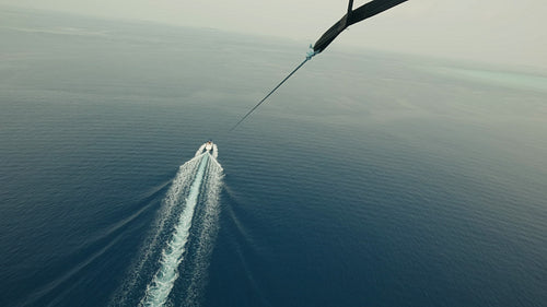 Parasailing over the deep blue ocean, an exciting water sport adventure experience