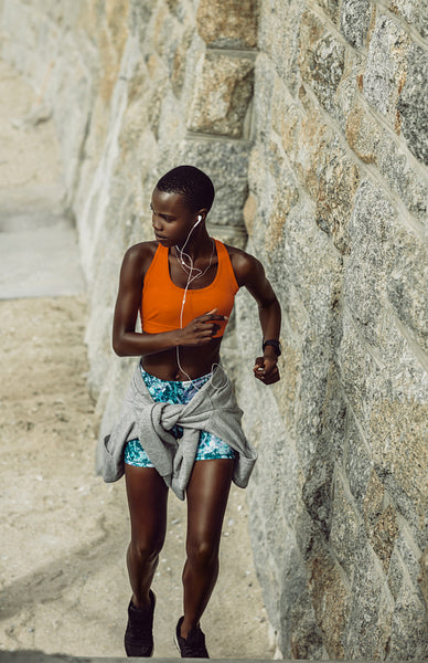 Healthy woman running upstairs outdoors