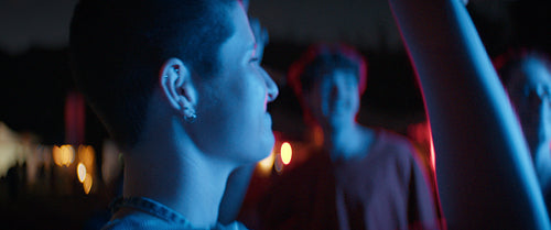 Young woman dancing with friends at a festival