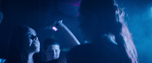 Diverse group of young adults dancing happily at music festival