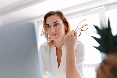 Business woman sitting in front of laptop