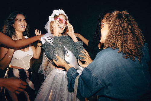 Group of friends celebrating a bride-to-be during a festive night out