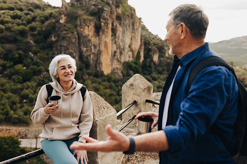 Carefree senior couple taking a coffee break on a hilltop