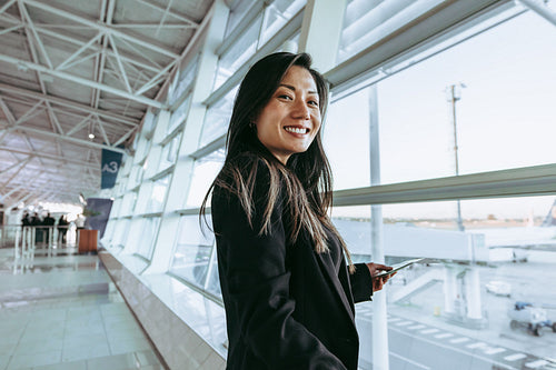 Woman at airport waiting to board airplane