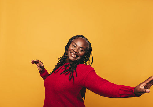 Cheerful black woman dancing in a studio