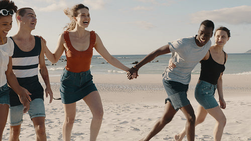 Friends enjoying walking at the beach