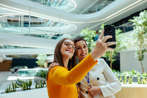 Female colleagues take a selfie on their first day at work