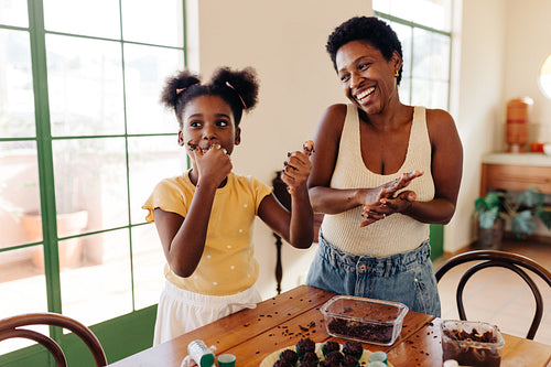 Sweet family time: Mom and daughter making traditional Brazilian brigadeiro together