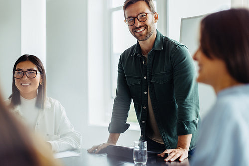 Business man leading a team meeting in an office