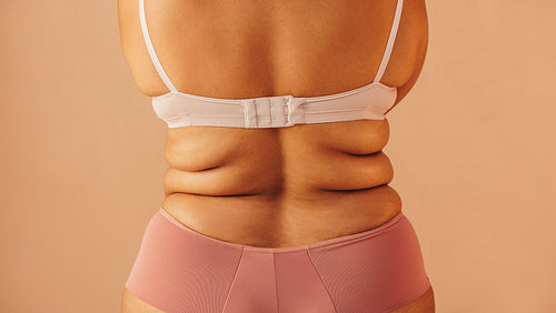 Rearview of a curvy woman wearing underwear in a studio
