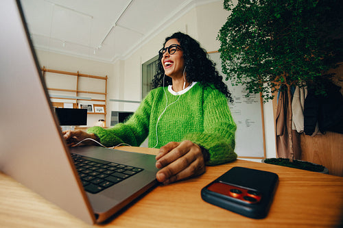 Business woman working at her desk with a laptop and phone in the office