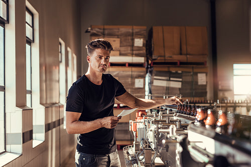 Brewer examining the beer production in brewery plant