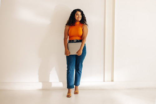Cheerful businesswoman looking away with a smile in an office