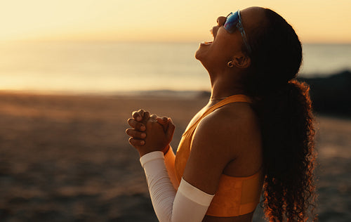 Champion celebration: Happy young athlete wins beach volleyball tournament at sunset