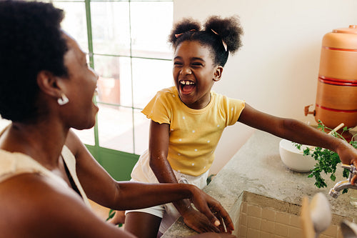 Mother and daughter fun in a Brazilian kitchen
