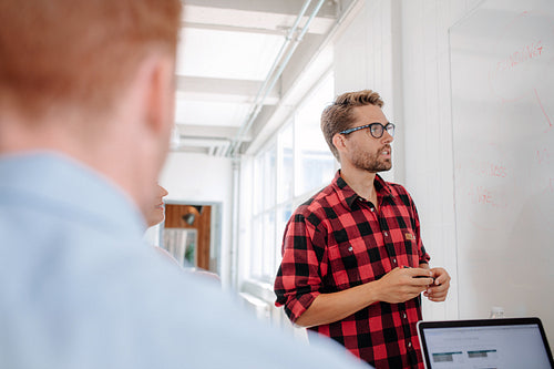 Businessman presenting to colleagues at a meeting