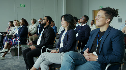 Diverse group of professionals attentively engaged in a corporate seminar or business conference