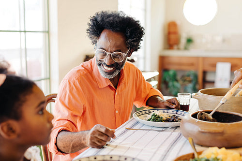 Cheerful brazilian family enjoying traditional meal together