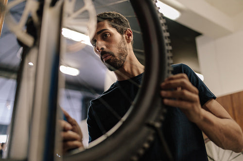 Mechanic repairing a bicycle in workshop