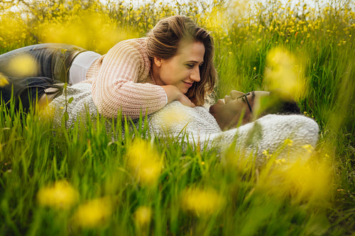 Young couple lying on the high grass