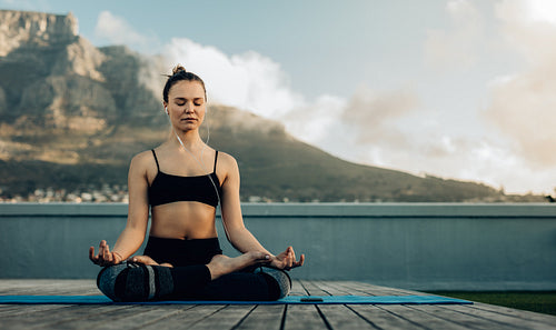 Woman relaxing doing outdoor yoga