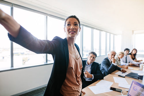 Asian businesswoman presenting her ideas to colleagues