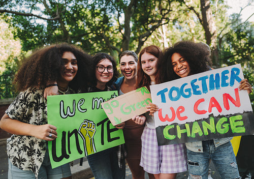 Multicultural teenage activists holding posters during a rally