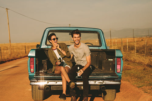 Couple enjoying on a road trip in their pick up truck